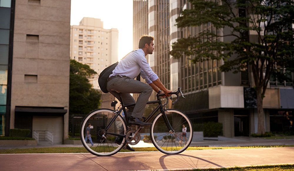 Thought leadership & latest news - Man biking in a city.